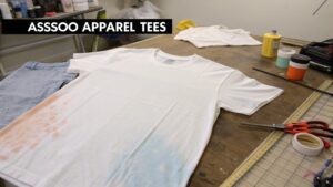 Person acid washing a cotton t-shirt with bleach for a vintage look